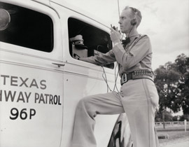 DPS trooper demonstrating mobile communications technology (circa 1940s).