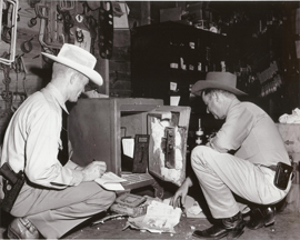 In this undated photo, Texas Rangers investigate a burglary that involved safe-cracking
