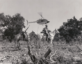 In this undated photo, Texas Rangers on horseback and on board the DPS helicopter demonstrate traditional and modern law enforcement transportation
