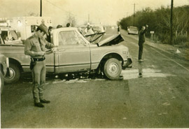 A Highway Patrol trooper investigates a crash near Austin in 1974.